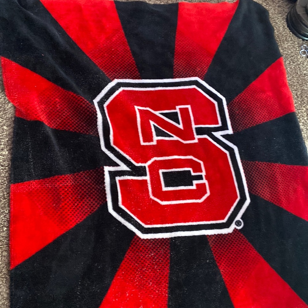 NC State blanket 4 by 5 feet long, feels like fake velvet, doesn’t have a tag.